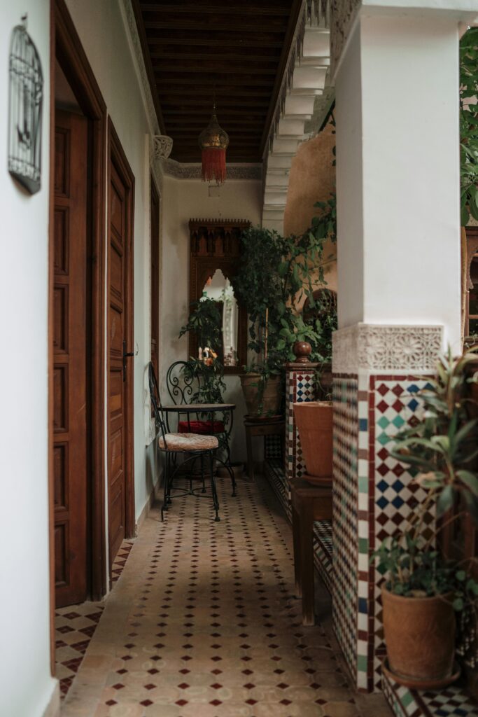 Elegant patio in Fes, Morocco, showcasing intricate tile designs and lush greenery, perfect for decor inspiration.