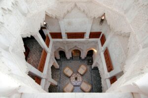 Stunning high-angle view of a traditional Moroccan riad courtyard in Marrakech, showcasing intricate architecture.