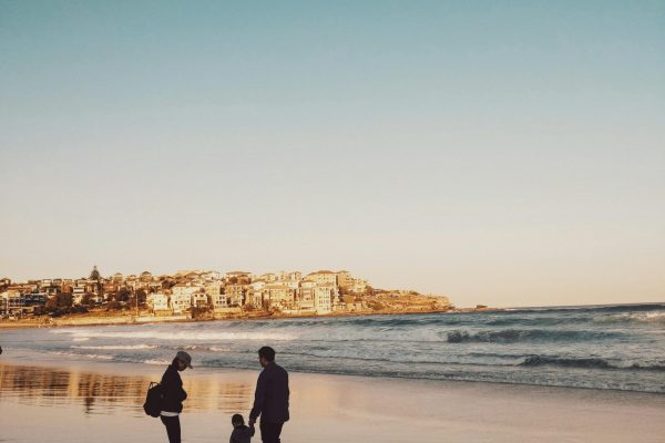 pexels-photo-1694649-1694649-1 Man and Woman Walking With Boy in Seashore