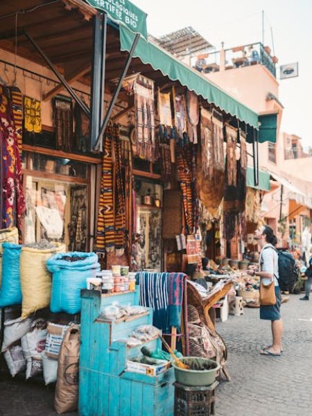 Vibrant scene at a Marrakesh street market showcasing diverse merchandise and lively atmosphere.