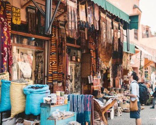 Vibrant scene at a Marrakesh street market showcasing diverse merchandise and lively atmosphere.